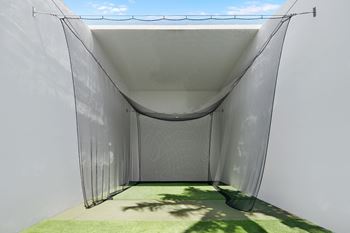 Outdoor golf practice net and turf area